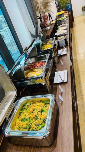 a buffet line with many trays of food at Trang An International Hotel in Ninh Binh