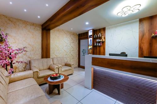 a living room with a couch and a table at Clover - A Rivido Hotel Jigani in Bengaluru