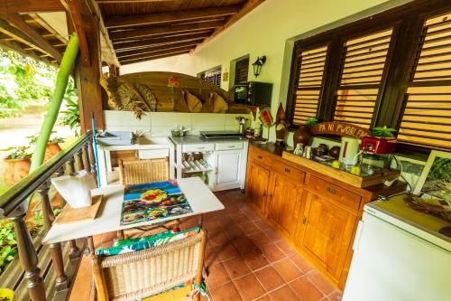 a kitchen with a counter and a table in it at Martinique Treehouse in Canton Suisse