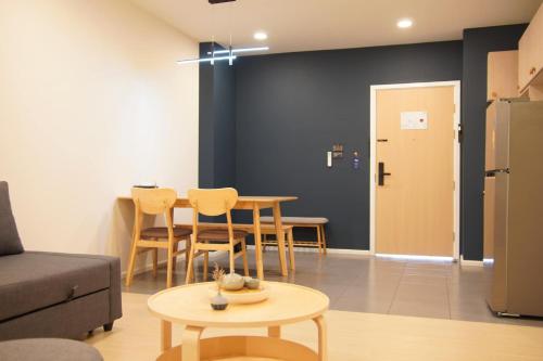 a living room with a couch and a table at Alto Hotel M in Mae Sot