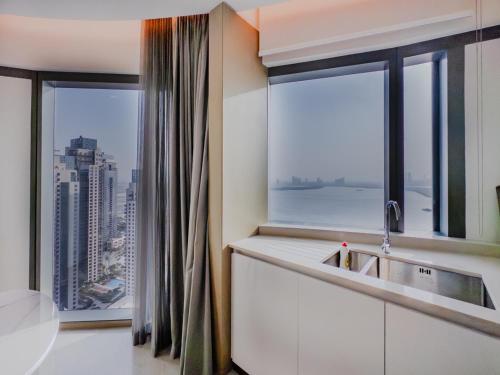 a kitchen with a large window with a view of a city at Dubai careek Harbour in Dubai