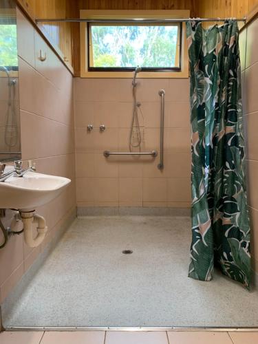 a bathroom with a sink and a shower at Iluka Retreat Glamping Village in Red Hill South