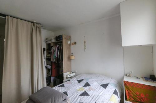a small bedroom with a bed and a closet at Charming 30 m love nest in Montreuil in Montreuil