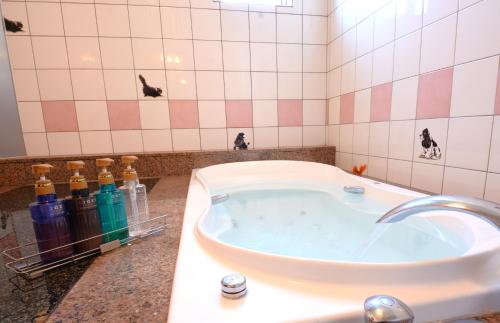 a bath tub in a bathroom with bottles on the counter at 水戸PARCO in Mito