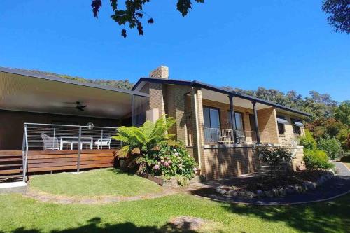 a house with a fence in front of it at Perfect Country Home in Tawonga