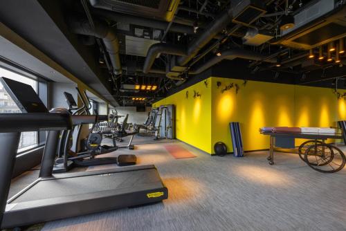 a gym with treadmills and bikes in a room at Mercure Tokyo Haneda Airport in Tokyo
