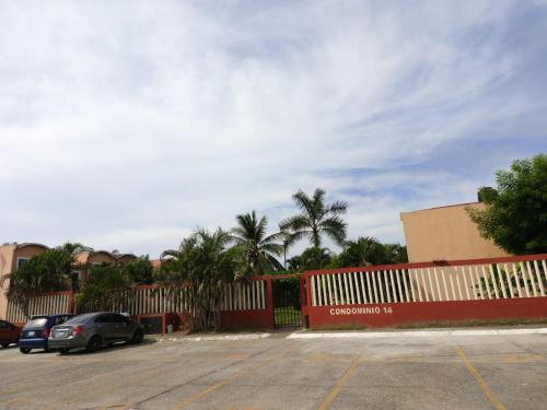 a car parked in a parking lot next to a fence at Casa el Palmar, the best house in Ixtapa in Ixtapa