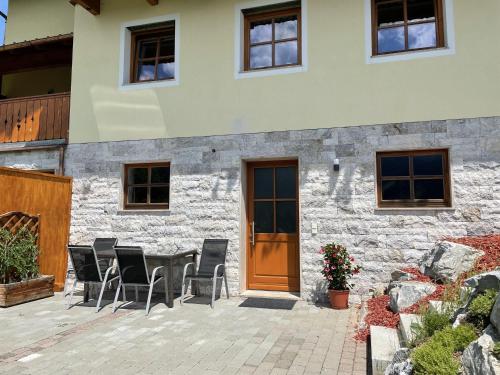 a patio with a table and chairs in front of a building at Mönchsberghof in Kleinarl