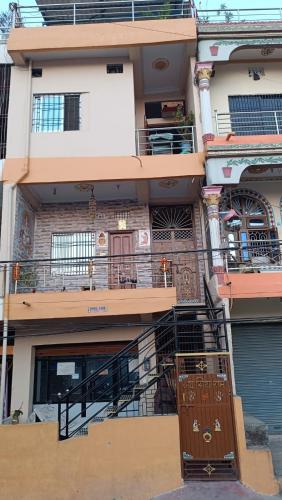 an apartment building with a staircase and a balcony at Mithila Culture Janakpurdham Homestay in Janakpur