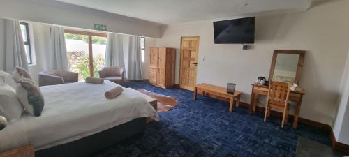 Ένα ή περισσότερα κρεβάτια σε δωμάτιο στο The Highlander Hotel Dullstroom