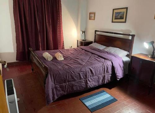 a bedroom with a bed with two hats on it at EL AMANECER - APART HUASI III in San Fernando del Valle de Catamarca
