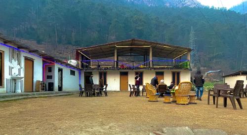 a group of people standing outside of a building at Damnbro Cafe & Stay KASOL in Kasol