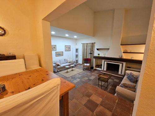 a living room with a table and a fireplace at Finca Altair in Madrid