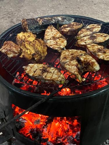 a bunch of meat is cooking on a grill at TETOAMAUI in Fare