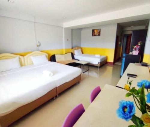 um quarto de hotel com uma cama grande e um sofá em โรงเเรมคิงส์พาเลซ King's Palace HOTEL em Seka