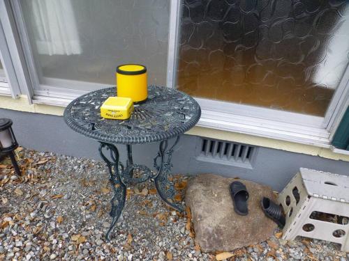 a table with a yellow cup on it next to a window at こや・かやき in Yufuin