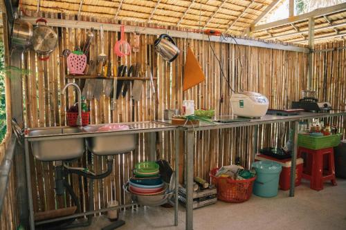 a kitchen with a sink and wooden walls at Homestay Bến Tre in Ben Tre