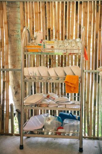 a metal shelf with dishes and plates on it at Homestay Bến Tre in Ben Tre