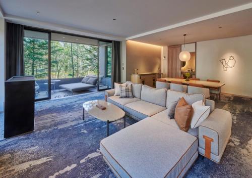 a living room with a couch and a table at Fufu Kyu-Karuizawa Seiyou No Mori in Karuizawa