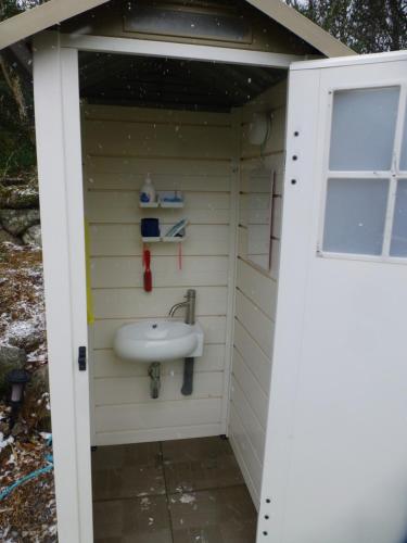 a bathroom with a sink in a shed at こや・かやき in Yufuin