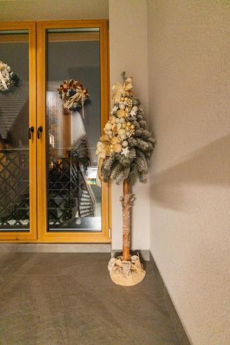 a christmas tree sitting in front of a door at Willa Trawers in Zakopane