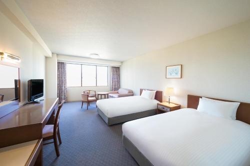 Postel nebo postele na pokoji v ubytování Grand Mercure Yatsugatake Resort & Spa