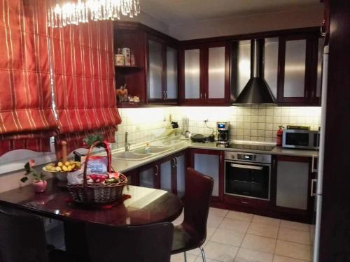 a kitchen with a table with a basket of fruit on it at Dana's Luxury Maisonette in Volos