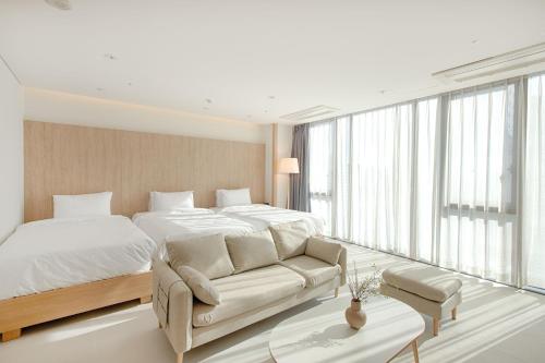 a bedroom with a large bed and a couch at Union Hotel in Seoul