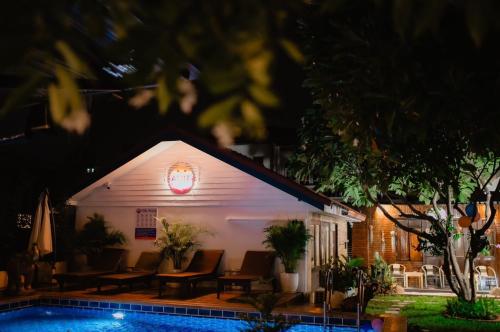 a building with a pool in front of it at night at Amit Resort 51 Hua Hin in Hua Hin