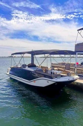 a boat tied up to a dock in the water at punta diamante nuevo altata sin. in Altata