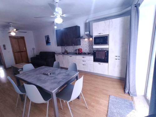 a kitchen and dining room with a table and chairs at Swieqi 3 bedroom apartment in St. Julianʼs