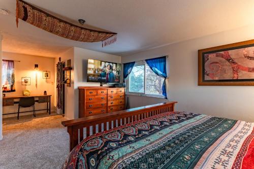 a bedroom with a bed and a dresser and a desk at Winnemucca Heights in Cascade-Chipita Park