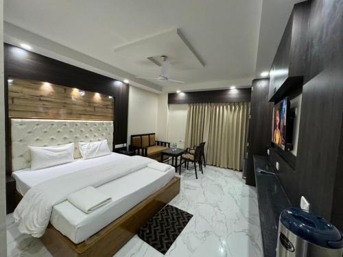 a bedroom with a large bed and a dining room at Rupasi Bangla-lll in Digha