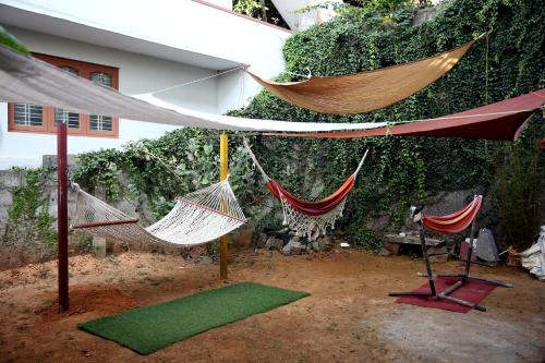 a group of hammocks hanging from a building at Cornwall for family in Madikeri