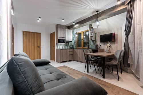 a living room with a couch and a table at Willa Trawers in Zakopane