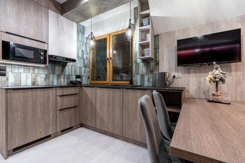 a kitchen with a large wooden table and chairs at Willa Trawers in Zakopane