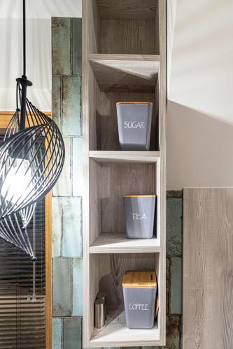 a wooden shelf with three pots in a room at Willa Trawers in Zakopane