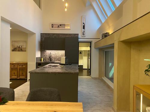 a kitchen with a counter and a sink in a room at Loft im Turm in Maishofen