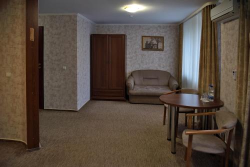 a living room with a table and a chair at Hotel Complex Ukraine in Luts'k