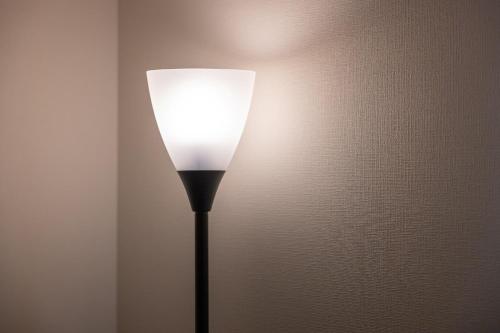 a lamp with a white shade on a wall at エイビル Ei building in Osaka