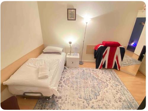 a small room with a bed and a rug at London Single Rooms Female only Kings Cross Eurostar St Pancras International Station Camden Euston all nearby check in from 1230 PM till 3AM in London