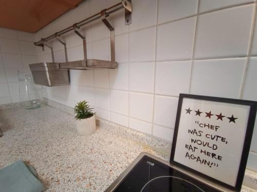 a sign in a kitchen with stars on the wall at F151 Elitehost Futó Apartment in Budapest