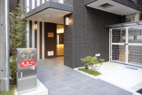 a parking meter in front of a building at エイビル Ei building in Osaka