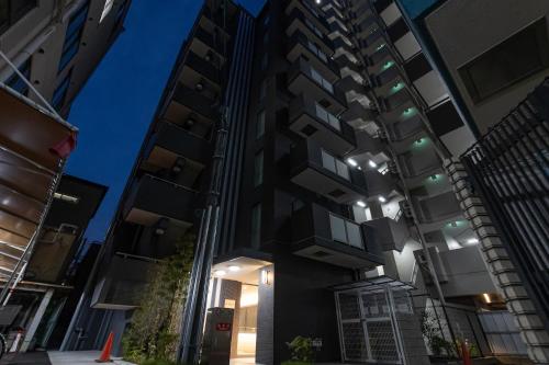 an apartment building at night with lights on at エイビル Ei building in Osaka