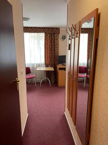 an open door to a room with a table and chairs at Hotel Complex Ukraine in Luts'k