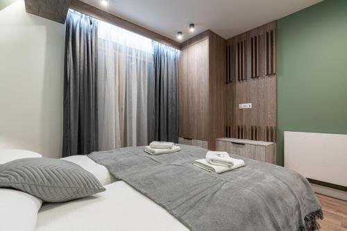 a bedroom with a bed with two towels on it at Willa Trawers in Zakopane