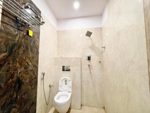 a bathroom with a toilet in a room at Hotel Nandini Palace ! Varanasi ! ! fully-Air-Conditioned-hotel family-friendly-hotel, near-Kashi-Vishwanath-Temple and Ganga ghat in Varanasi