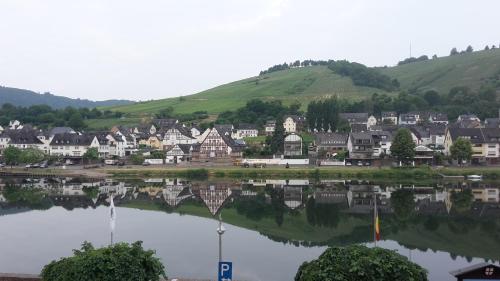 a small town with a reflection in a lake at Mosel View Old Town Apartments in Zell an der Mosel