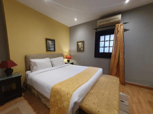 a bedroom with a large bed and a window at The Cosy Hotel in Zamalek in Cairo