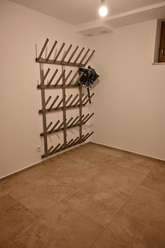 a room with a wall with wooden racks on the wall at Nicky apartments and studios in Niederau